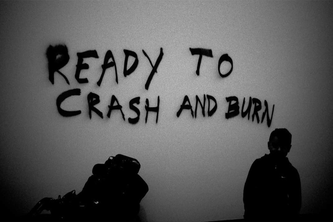 Words painted on a wall above two figures