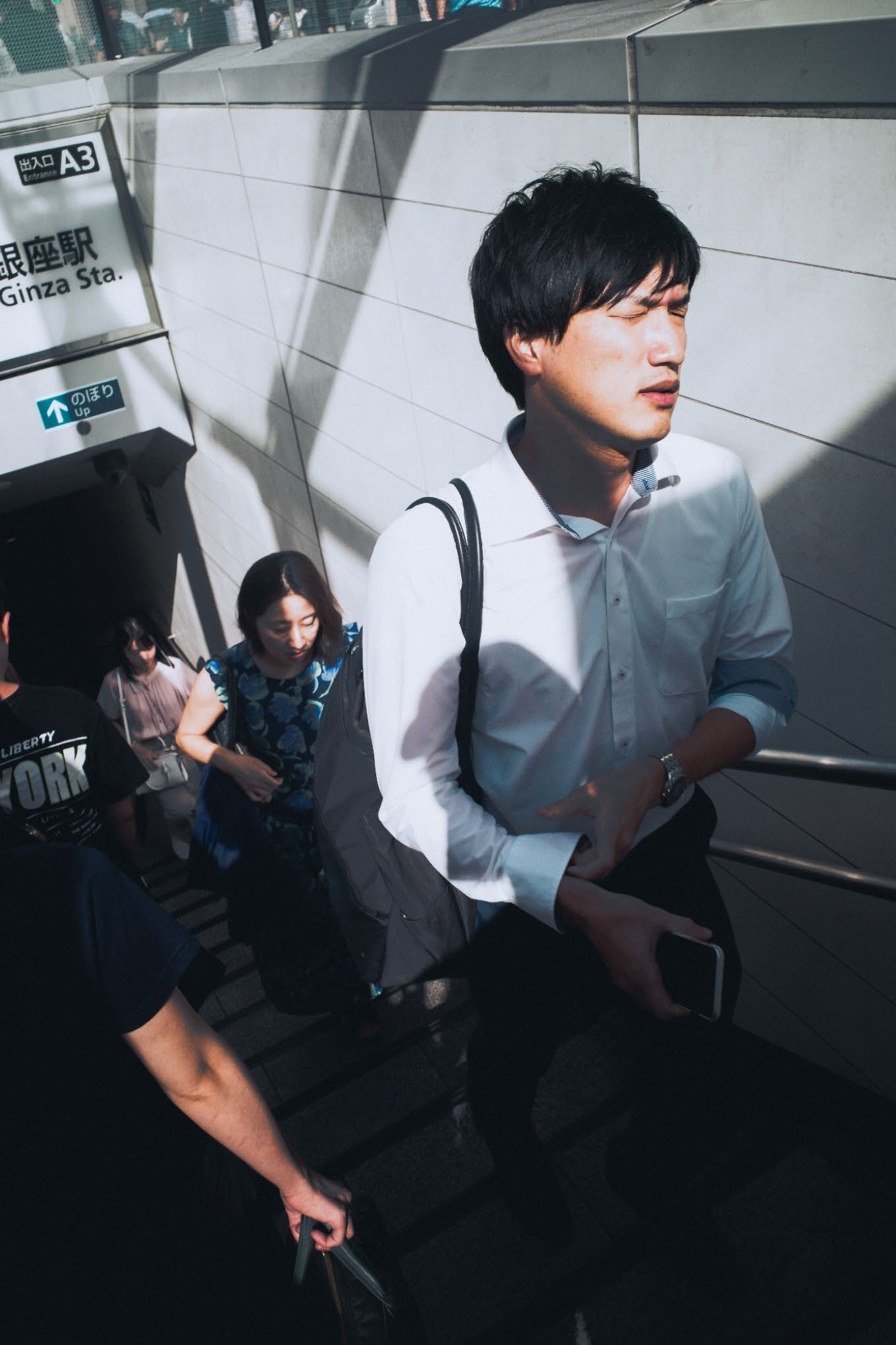 A young man descending a subway stairway