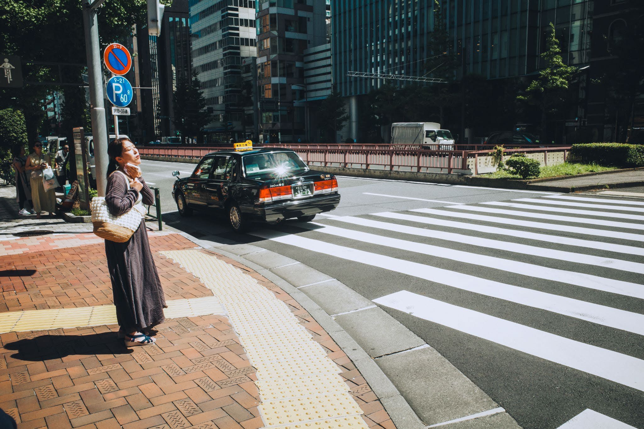 A pedestrian beside a city crosswalk
