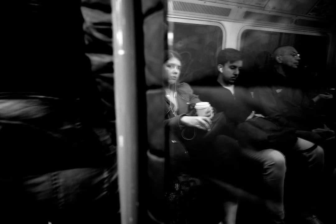 Passengers seen through a train window