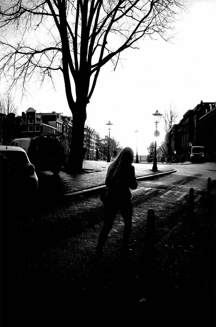 People gathered beside bare trees