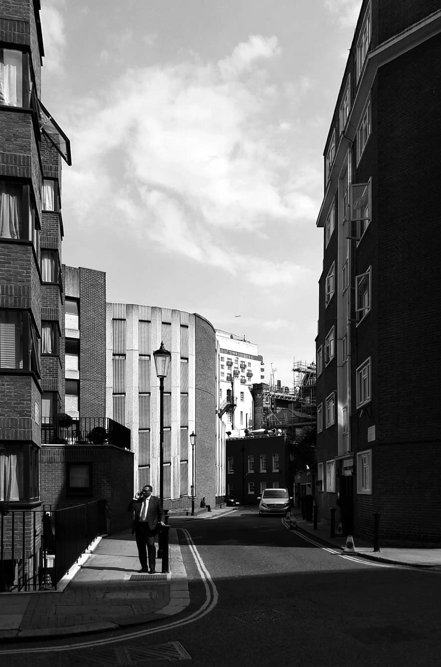 A quiet street framed by tall buildings